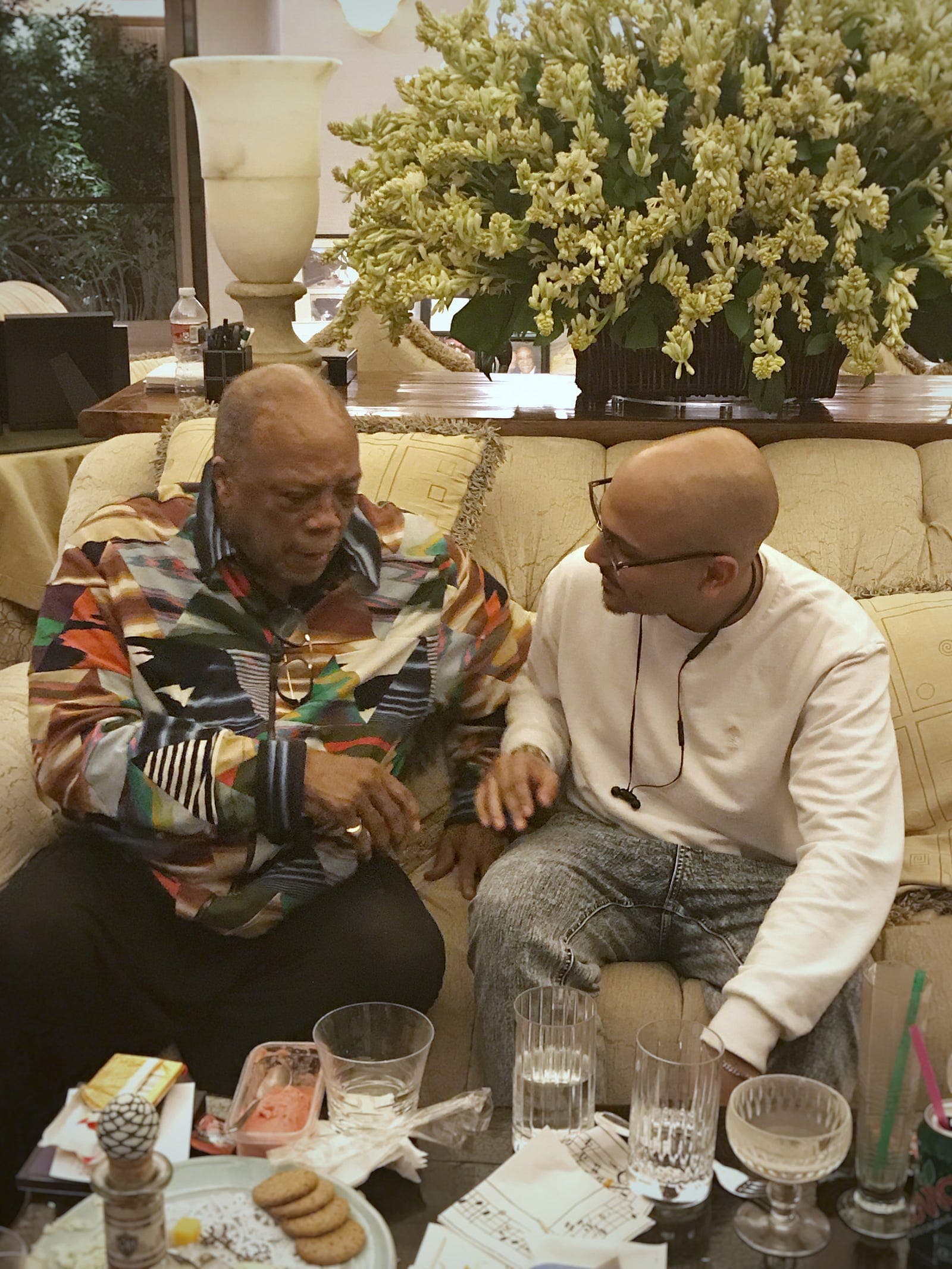 Anik Devaughn in conversation with Quincy Jones, seated together at Quincy Jones's Bel-Air home